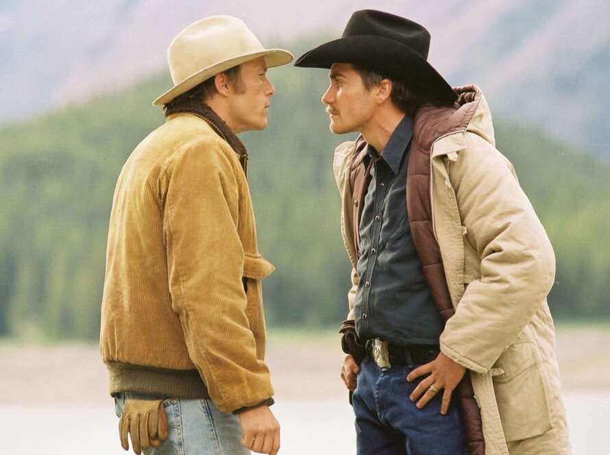 Two cowboys facing each other outdoors.