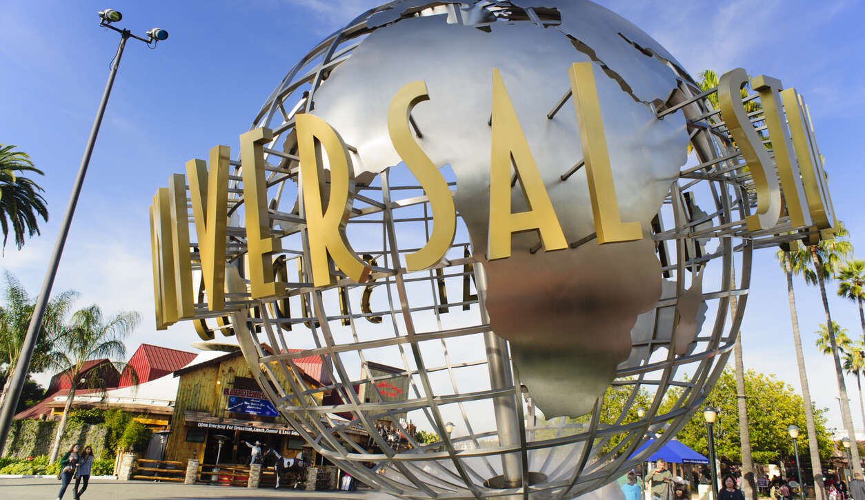 Universal Studios globe with iconic gold lettering at entrance.