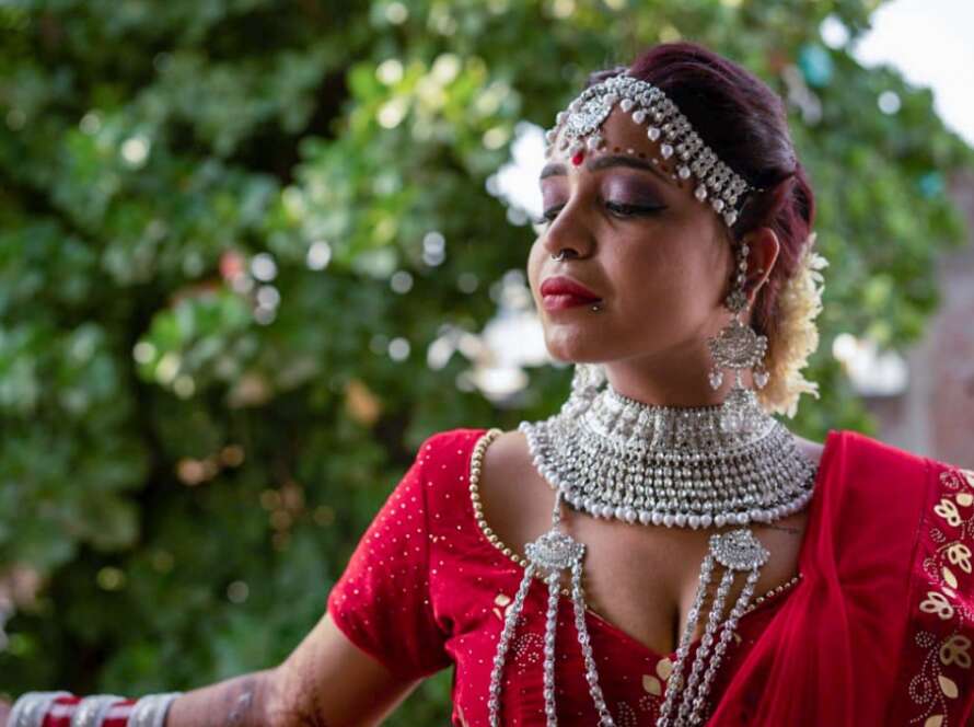 Woman in traditional attire with jewelry.