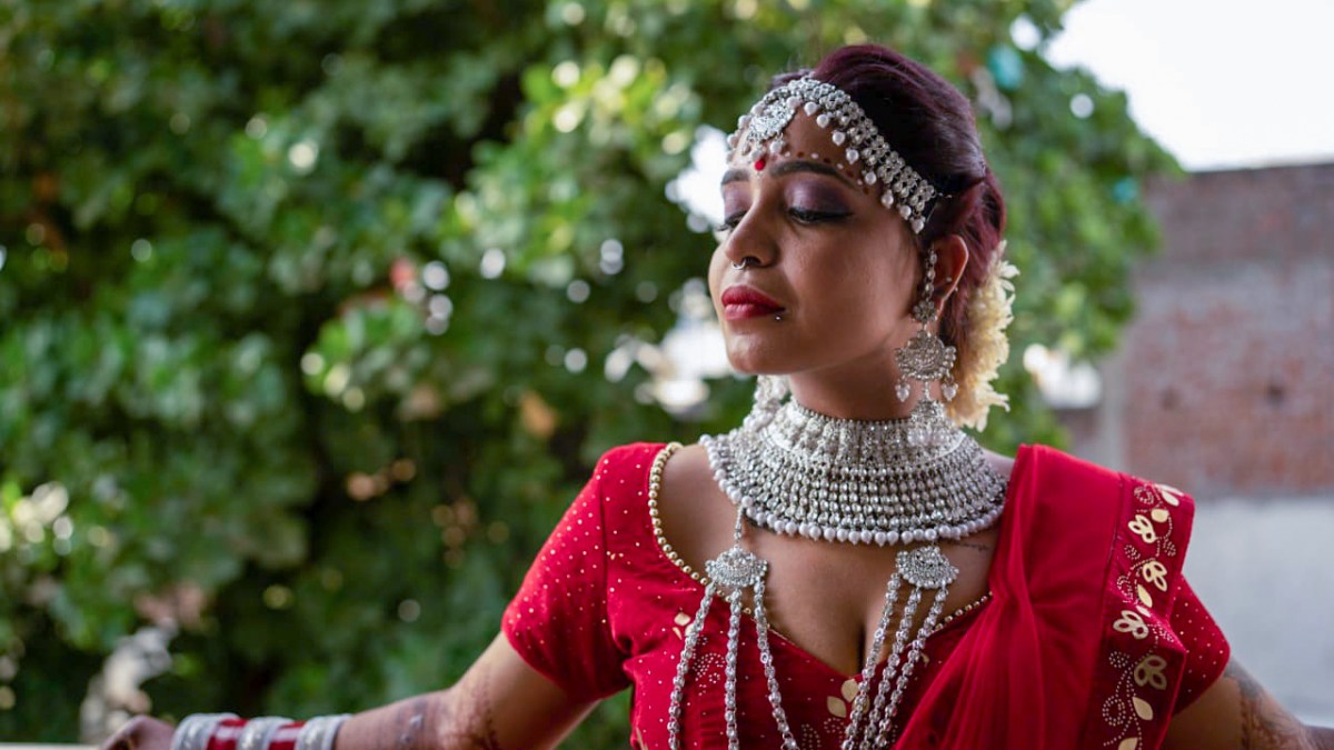 Woman in traditional attire with jewelry.